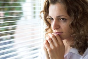 woman looking out window needs anxiety treatment