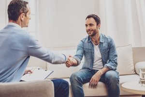 a man shakes hand with his counselor during outpatient addiction treatment in Joliet